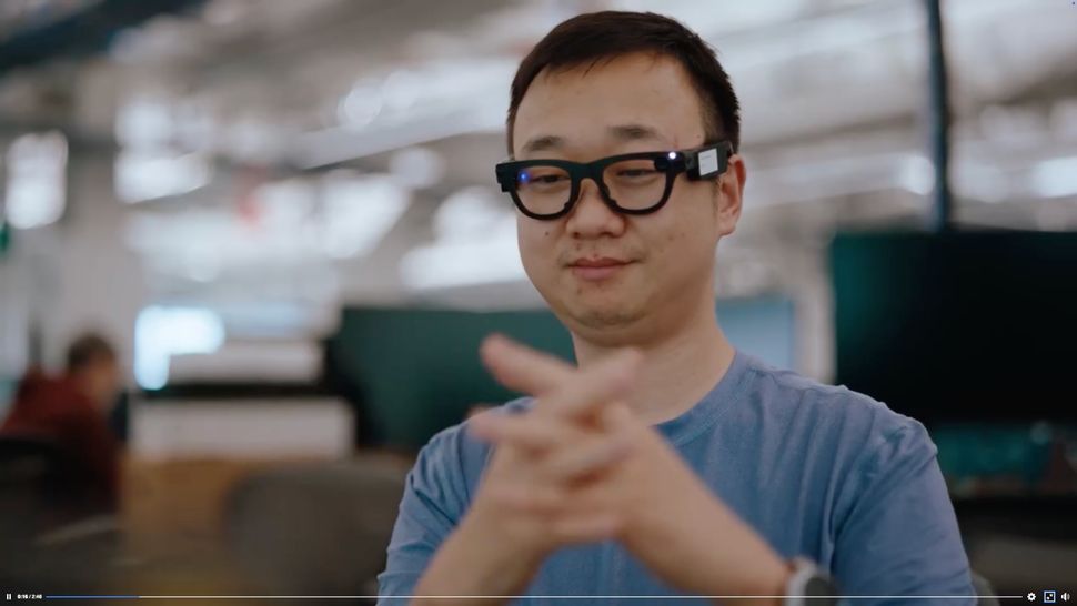 Tiêu đề: Kính thông minh Meta Aria Gen 2: Bước tiến vượt bậc so với Ray-Ban Meta - Still from a promotional video about Meta Project Aria Gen 2, showing an engineer wearing Aria smart glasses and testing the hand tracking capabilities